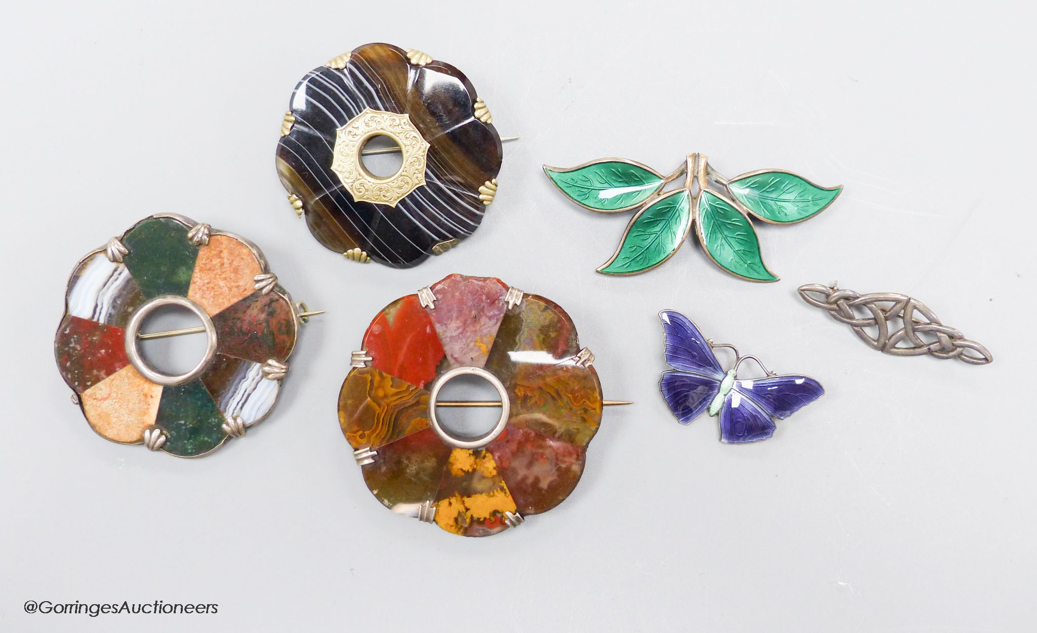 Two sterling and enamel brooches, including butterfly, 37mm, one other white metal brooch and three hardstone set brooches.